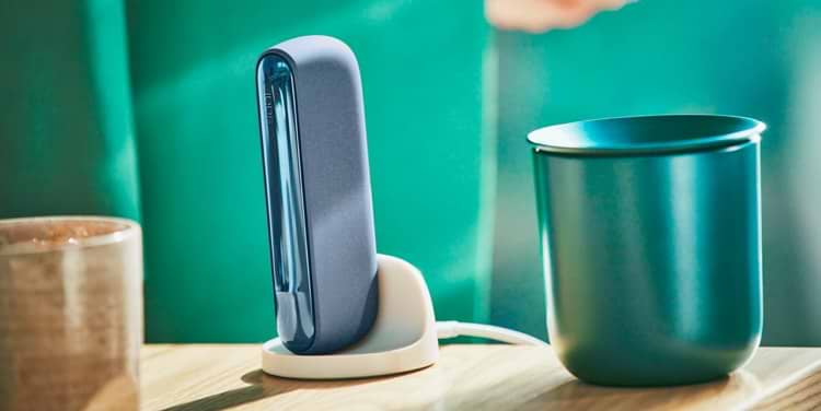 An IQOS ILUMA Pocket Charger in a charging station.