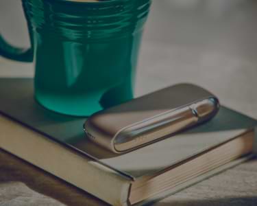 Young man opens his IQOS gift box