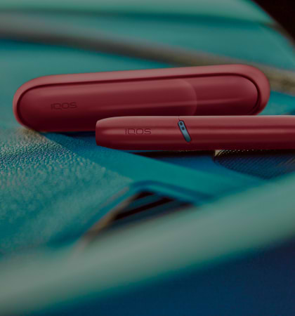 IQOS Originals Duo holder and pocket charger in red color.	