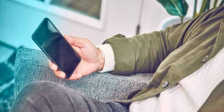 A hand holding a smartphone.