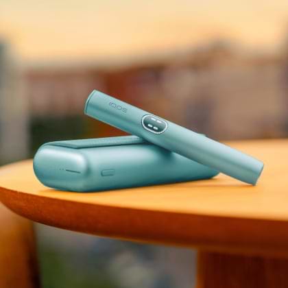 A jade green IQOS ILUMA PRIME Pocket Charger and Holder.