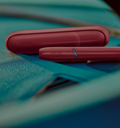 IQOS Originals Duo holder and pocket charger in red color.	