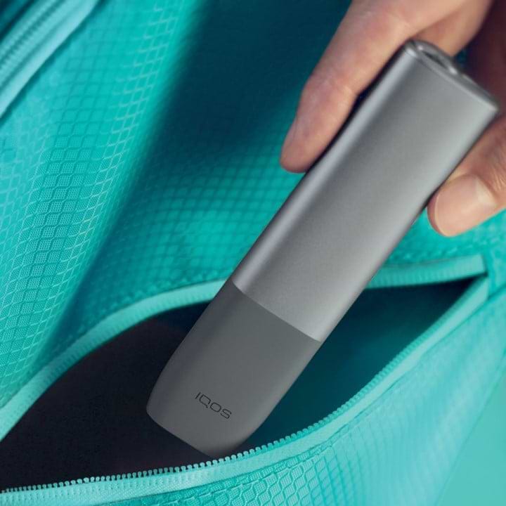 An IQOS ILUMA device and mobile phone.