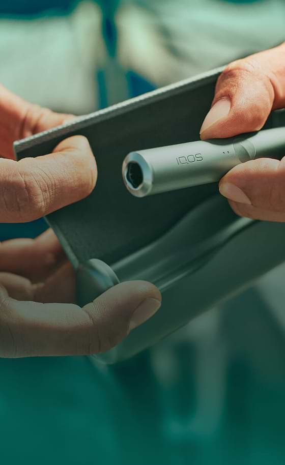 A jade green IQOS ILUMA PRIME Holder and Pocket Charger.