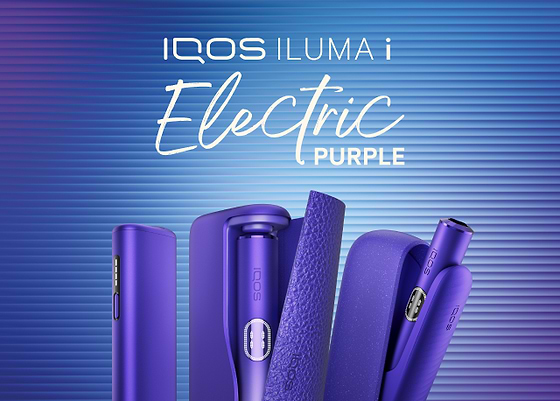 A blue IQOS device on a wooden table. 