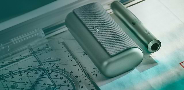 A Jade Green IQOS ILUMA PRIME Pocket Charger and Holder.