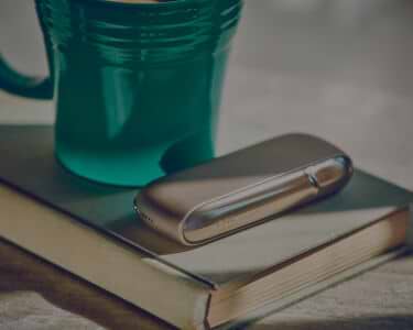 Young man opens his IQOS gift box