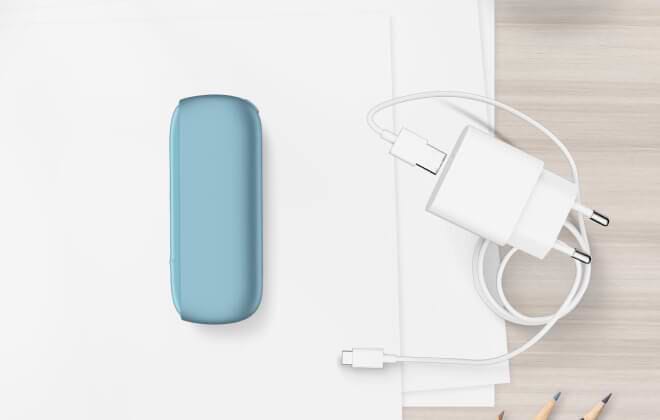 Turquoise IQOS ORIGINALS DUO pocket charger next to cable charger.	