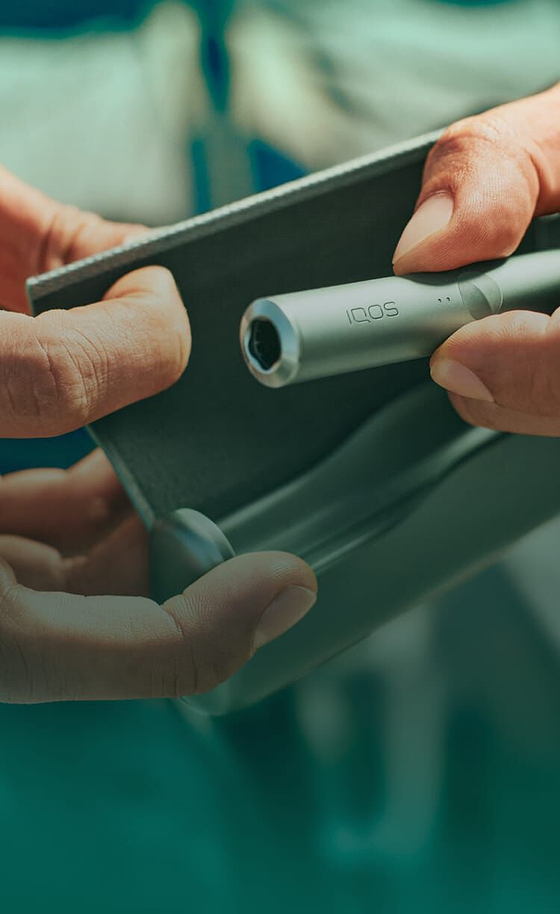 A jade green IQOS ILUMA PRIME Holder and Pocket Charger.