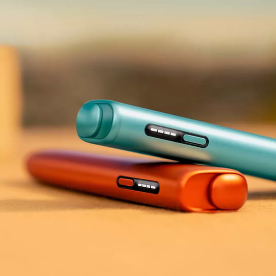 A jade green IQOS ILUMA PRIME Pocket Charger and Holder.