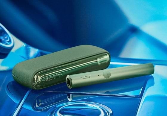 A moss green IQOS ILUMA device.