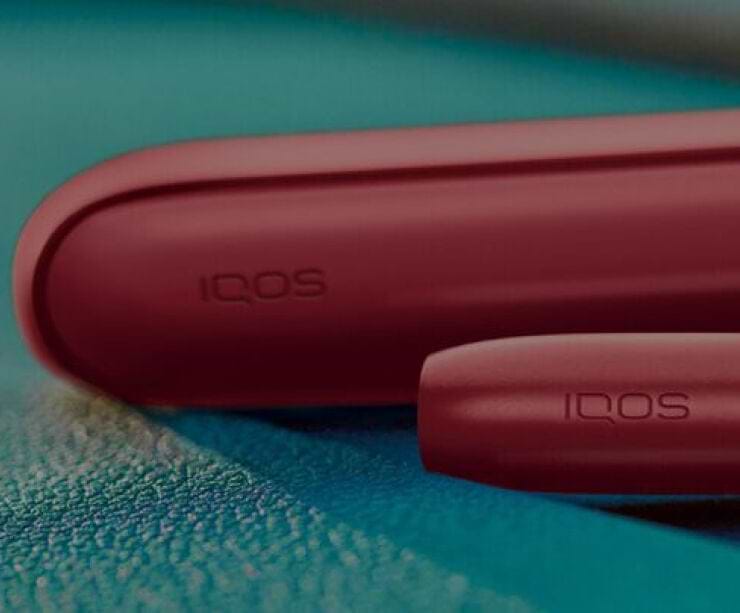 IQOS packaging on a glass table