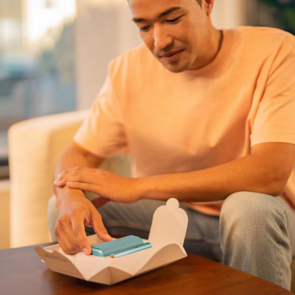 A jade green IQOS ILUMA PRIME Pocket Charger and Holder.
