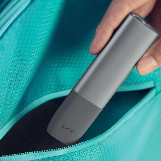 An IQOS ILUMA device and mobile phone.