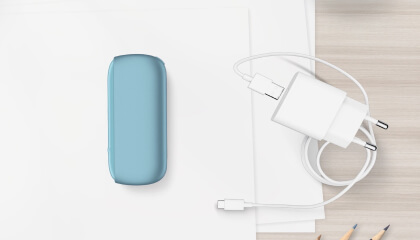Turquoise IQOS ORIGINALS DUO pocket charger next to cable charger.	