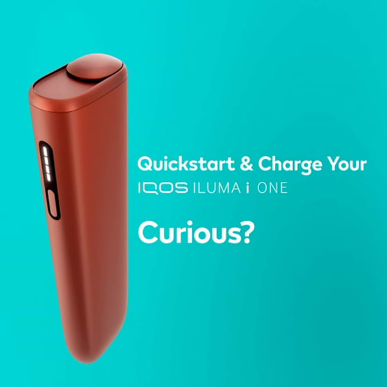 A charging cable being inserted into an IQOS ILUMA PRIME holder.