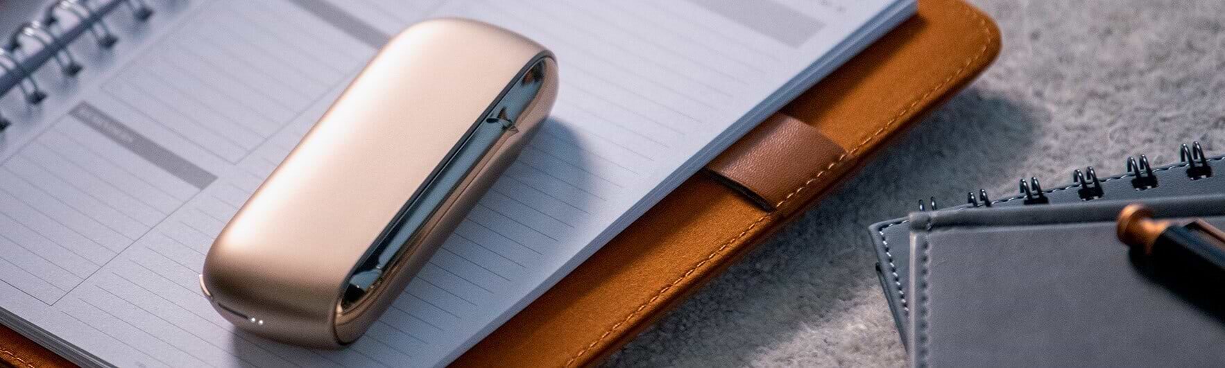 An IQOS kept on a notepad