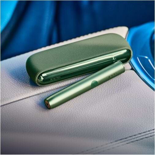 Hands holding IQOS ILUMA PRIME Pocket Chargers.