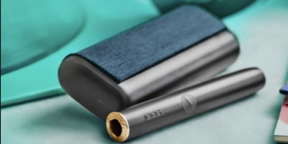 A person places a TEREA stick into an IQOS ILUMA PRIME Holder.