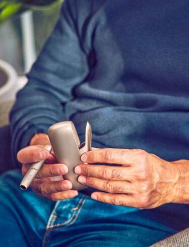 IQOS packaging on a glass table