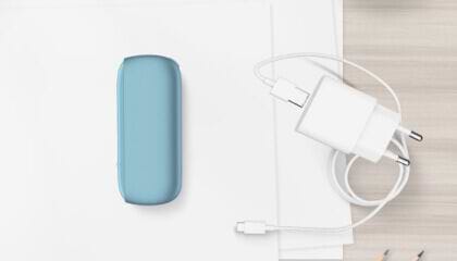 Turquoise IQOS ORIGINALS DUO pocket charger next to cable charger.	 	 	