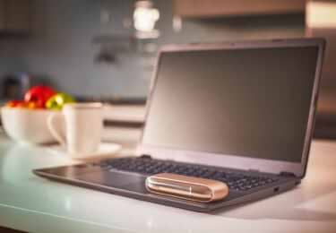 Gold IQOS DUO on a laptop