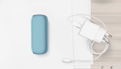 Turquoise IQOS ORIGINALS DUO pocket charger next to cable charger.	 	 	